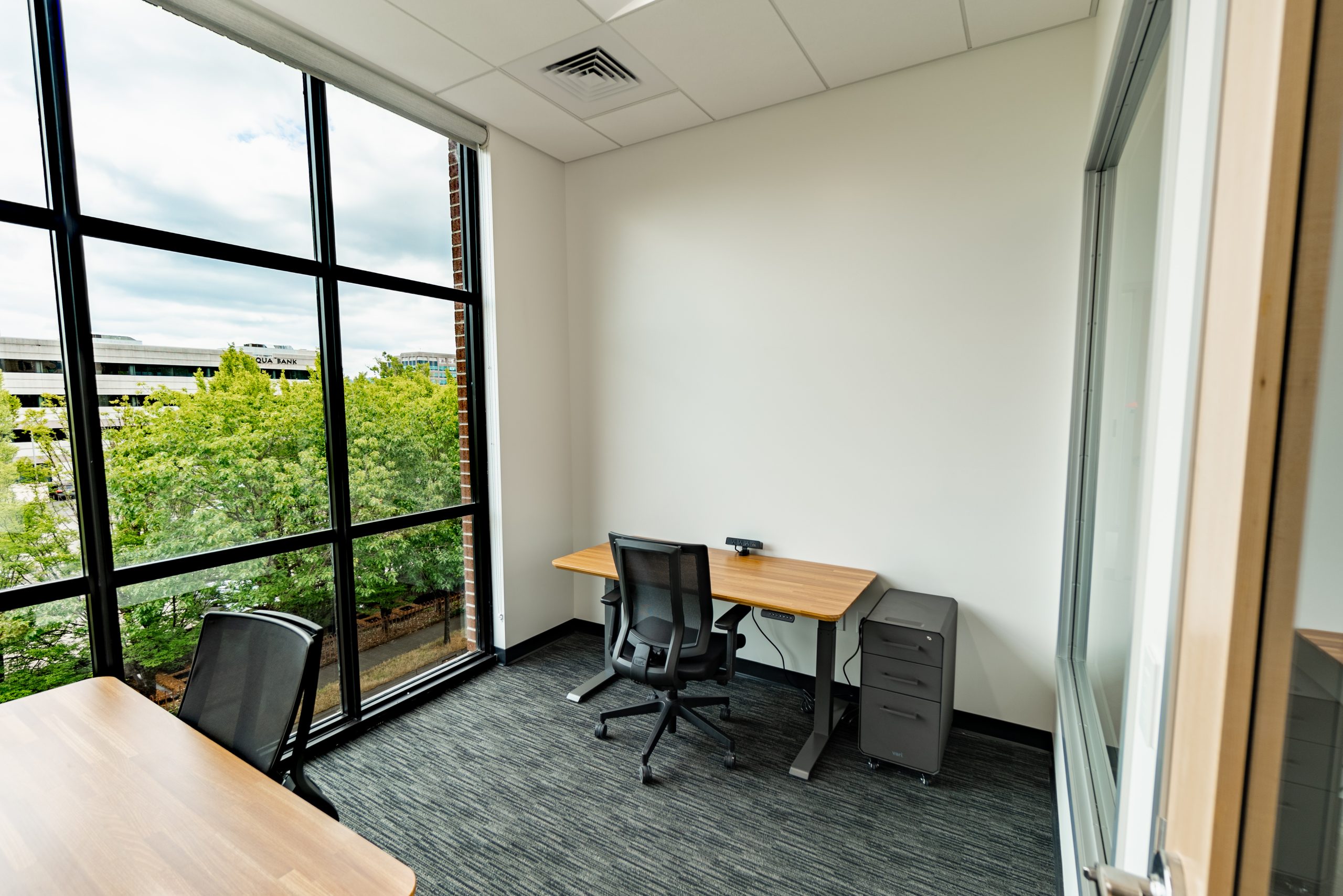 Coworking lounge with high ceilings and natural light.