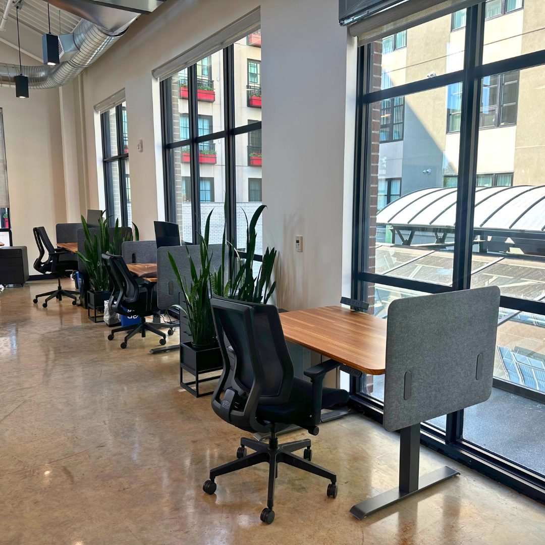 Coworking lounge with high ceilings and natural light.