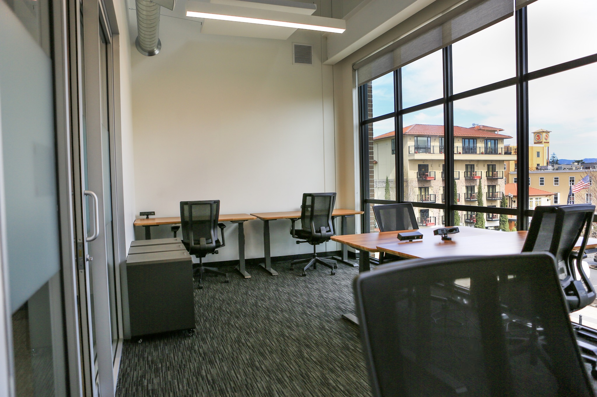 Coworking lounge with high ceilings and natural light.